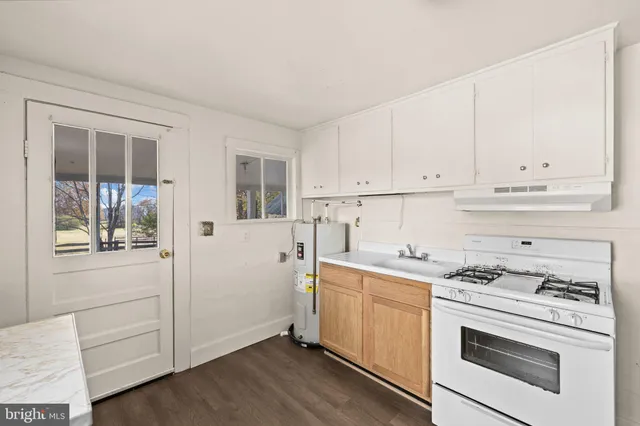 a view of a hallway with a white walls and stairs
