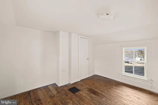a view of a kitchen with stainless steel appliances a refrigerator and a stove top oven