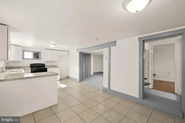 a kitchen with granite countertop white cabinets and white appliances