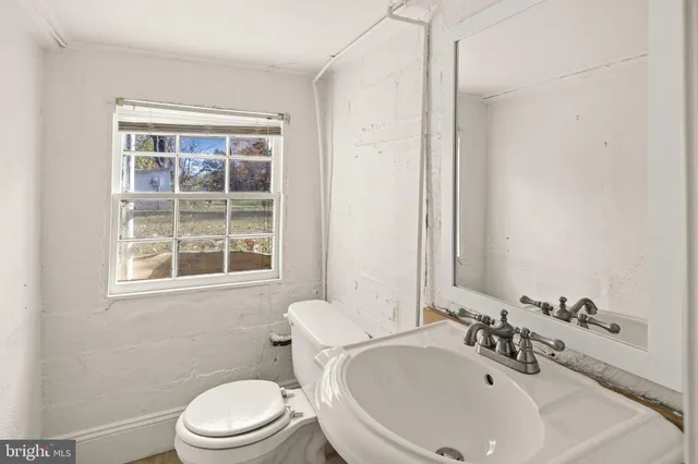 a view of a room with wooden floor and windows