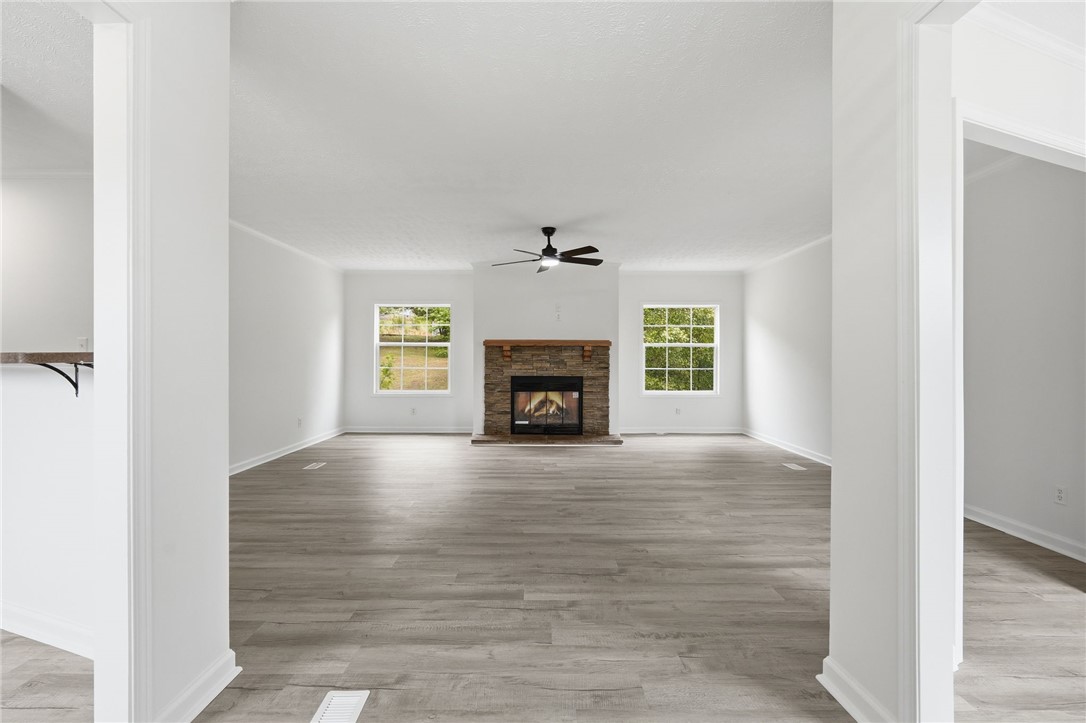 112 Sir Francis Drake Way Liberty, SC 29657 - Photo 12 of 42 This expansive living area features elegant flooring and a cozy fireplace, perfect for relaxation.