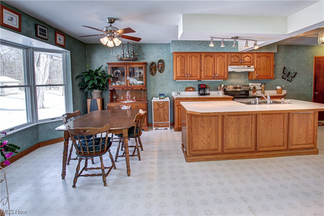 3711 Ruth Drive Brunswick, OH 44212 - Photo 4 of 35 Kitchen with light tile floors, sink, stainless steel electric range, ceiling fan, and rail lighting