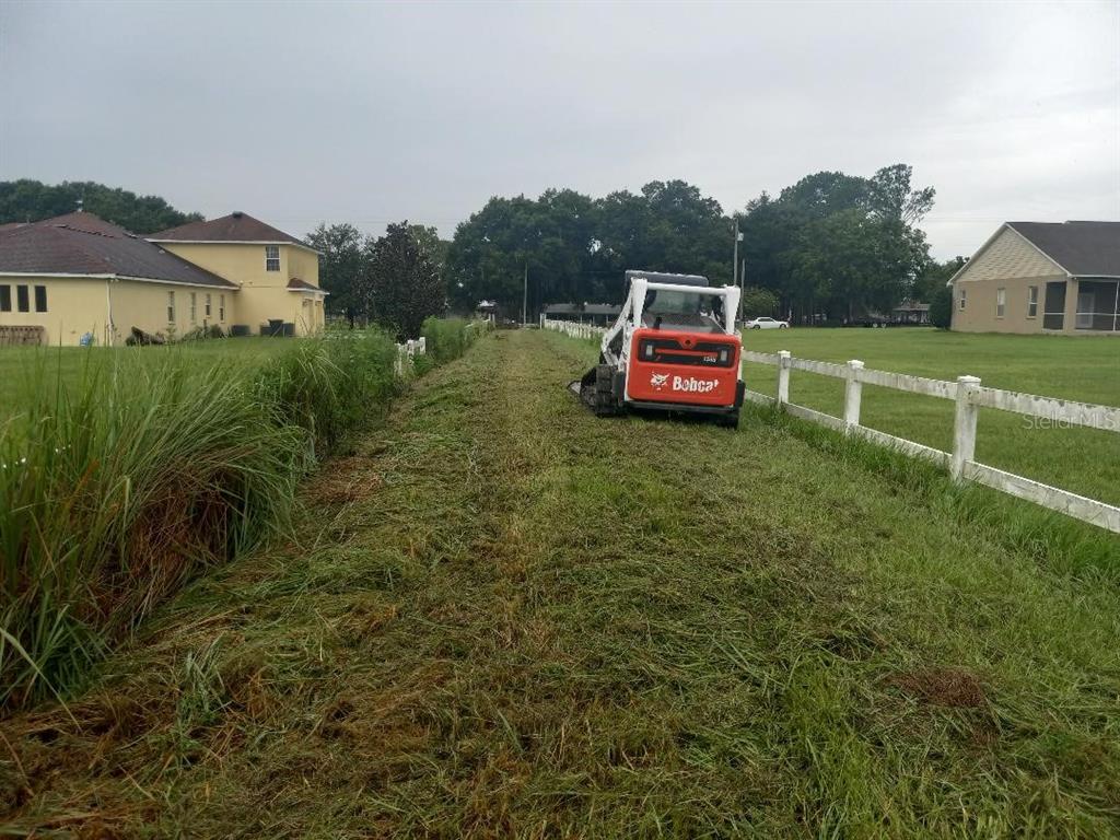 3408 North Forbes Road Plant City, FL 33565 - Photo 2 of 5 a car parked in front of a house with a yard