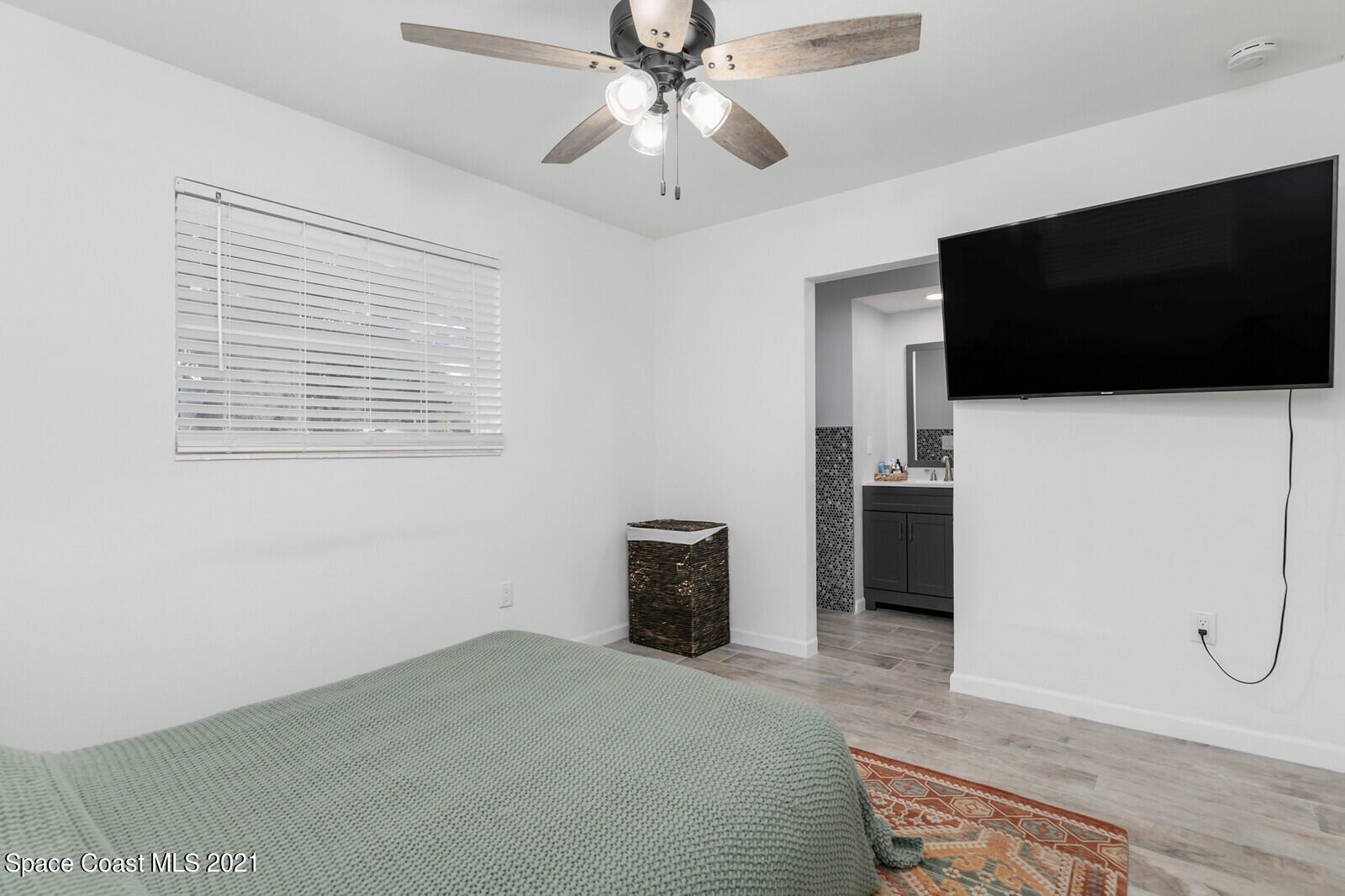 865 Osage Avenue Melbourne, FL 32935 - Photo 12 of 38 a bedroom with a bed and a flat screen tv