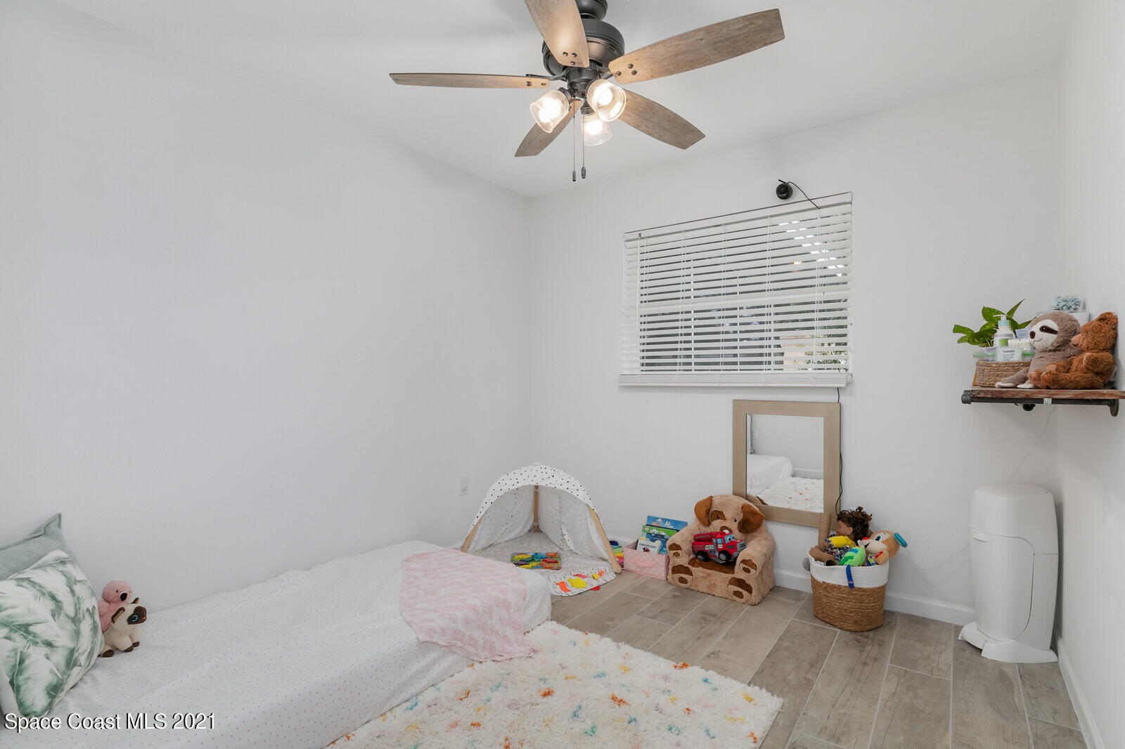 865 Osage Avenue Melbourne, FL 32935 - Photo 15 of 38 a bedroom with furniture and a window