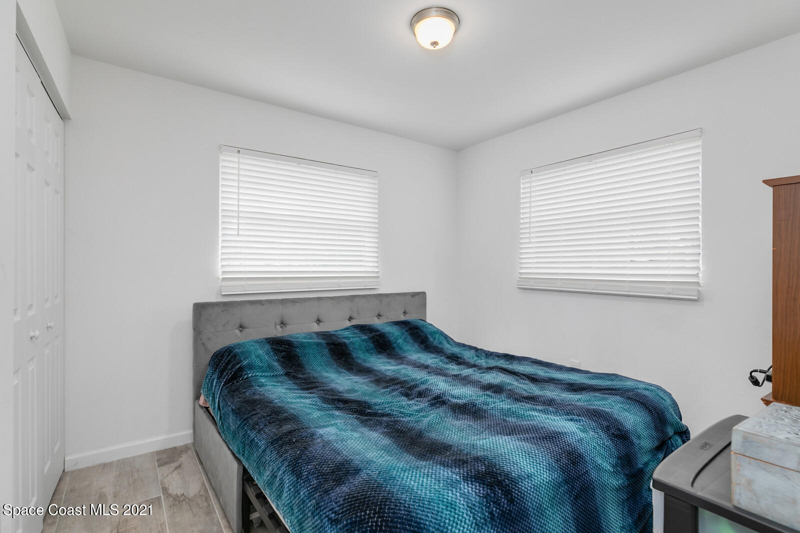 865 Osage Avenue Melbourne, FL 32935 - Photo 16 of 38 a bedroom with a bed and a window