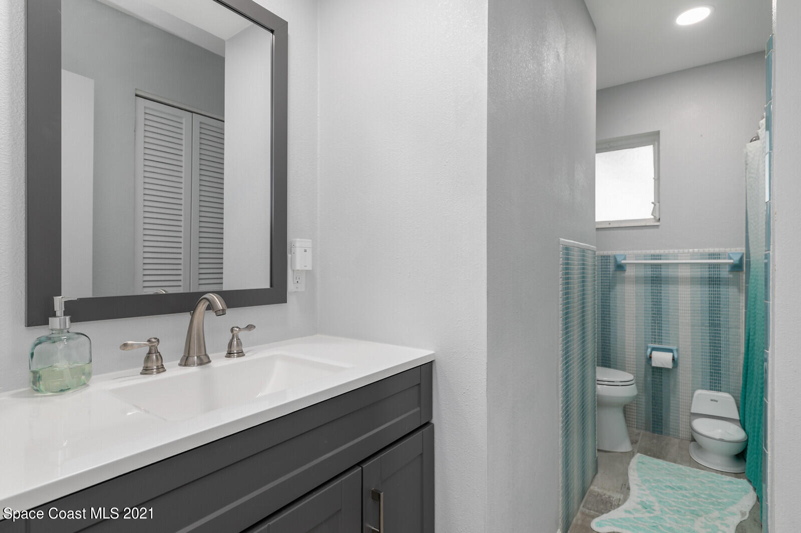 865 Osage Avenue Melbourne, FL 32935 - Photo 17 of 38 a bathroom with a sink and a mirror