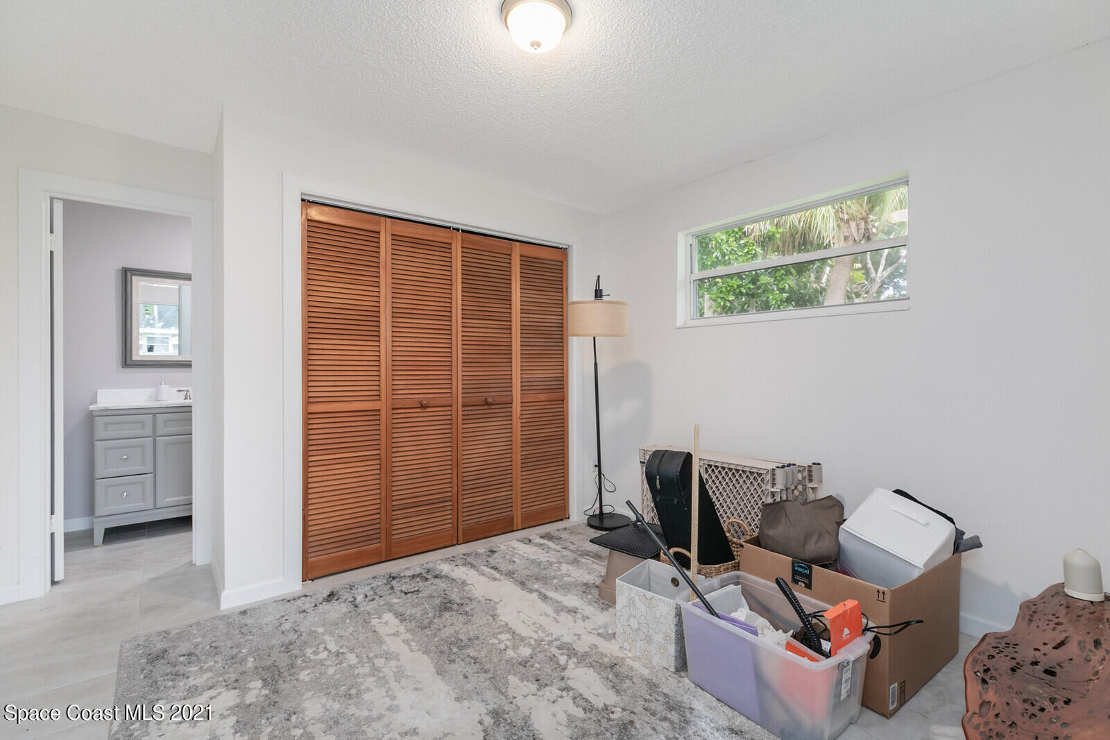 865 Osage Avenue Melbourne, FL 32935 - Photo 18 of 38 a view of a livingroom with workspace and a couch