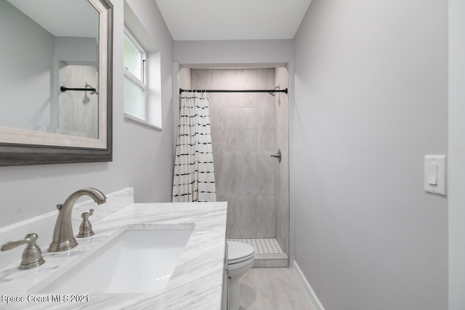 865 Osage Avenue Melbourne, FL 32935 - Photo 19 of 38 a bathroom with a sink and a mirror