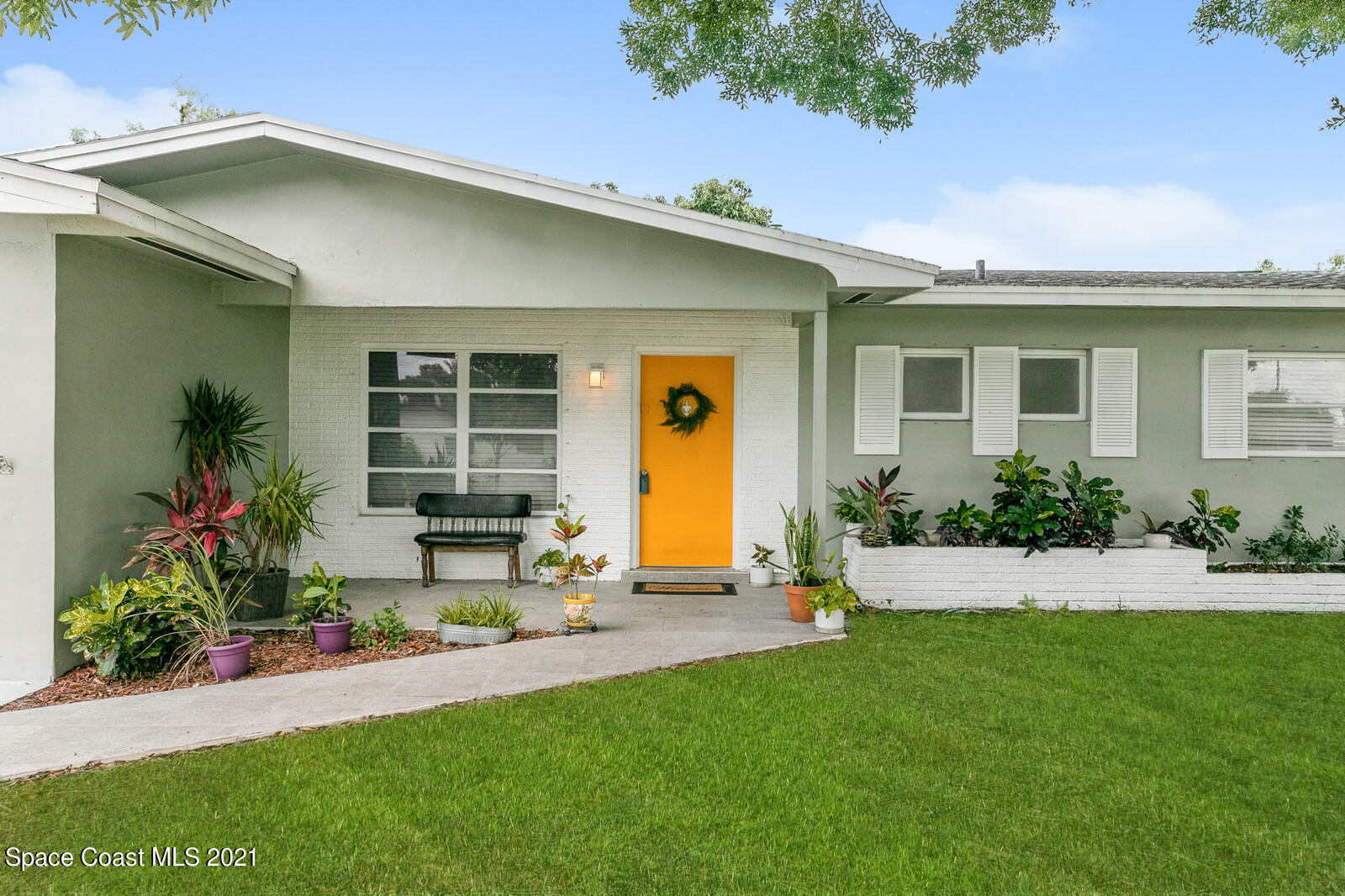 865 Osage Avenue Melbourne, FL 32935 - Photo 3 of 38 a front view of a house with garden
