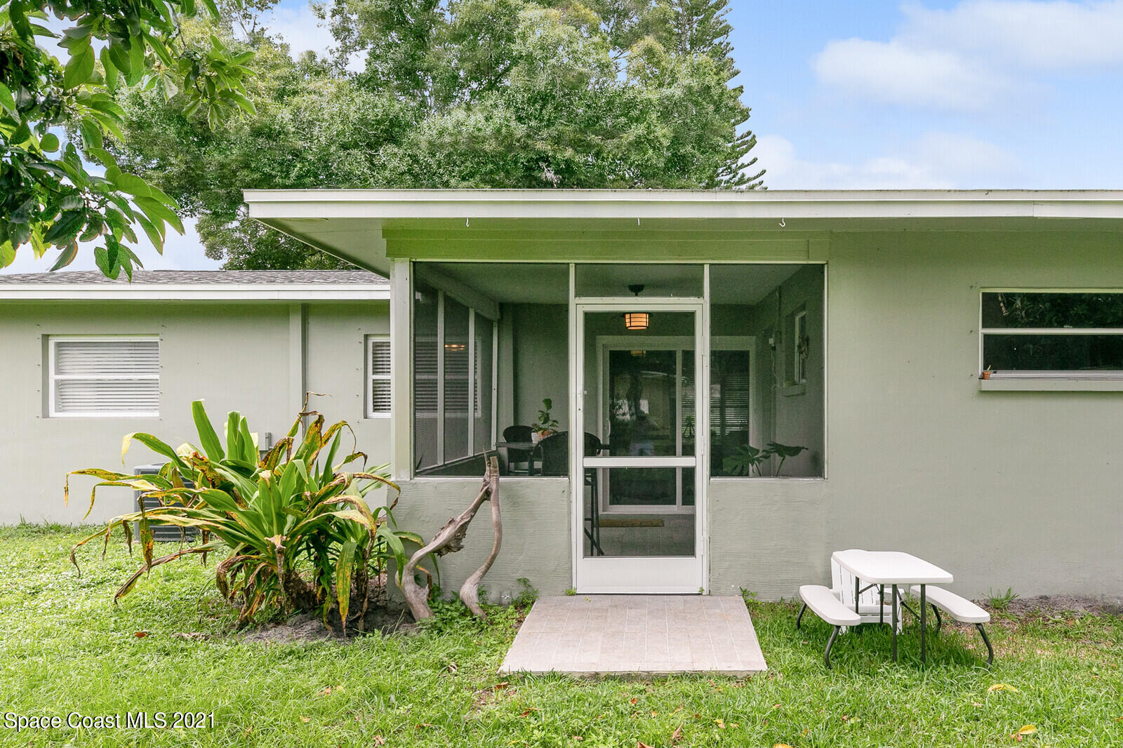 865 Osage Avenue Melbourne, FL 32935 - Photo 23 of 38 a front view of a house with garden