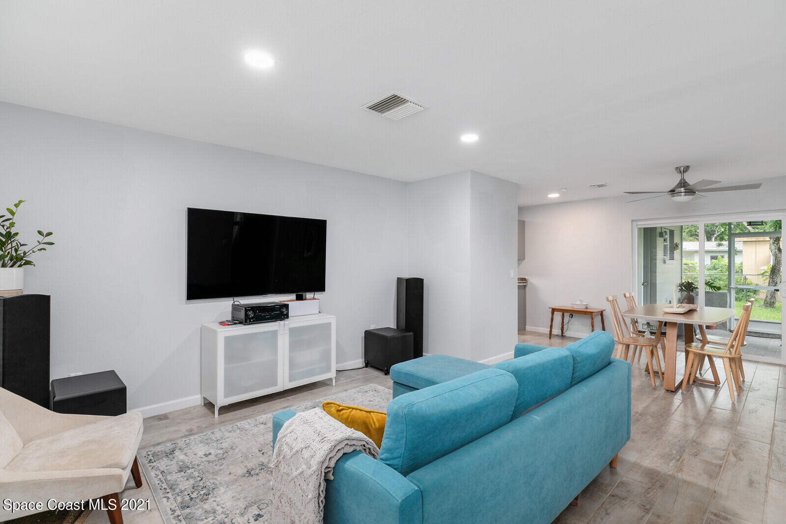 865 Osage Avenue Melbourne, FL 32935 - Photo 9 of 38 a living room with furniture and a flat screen tv