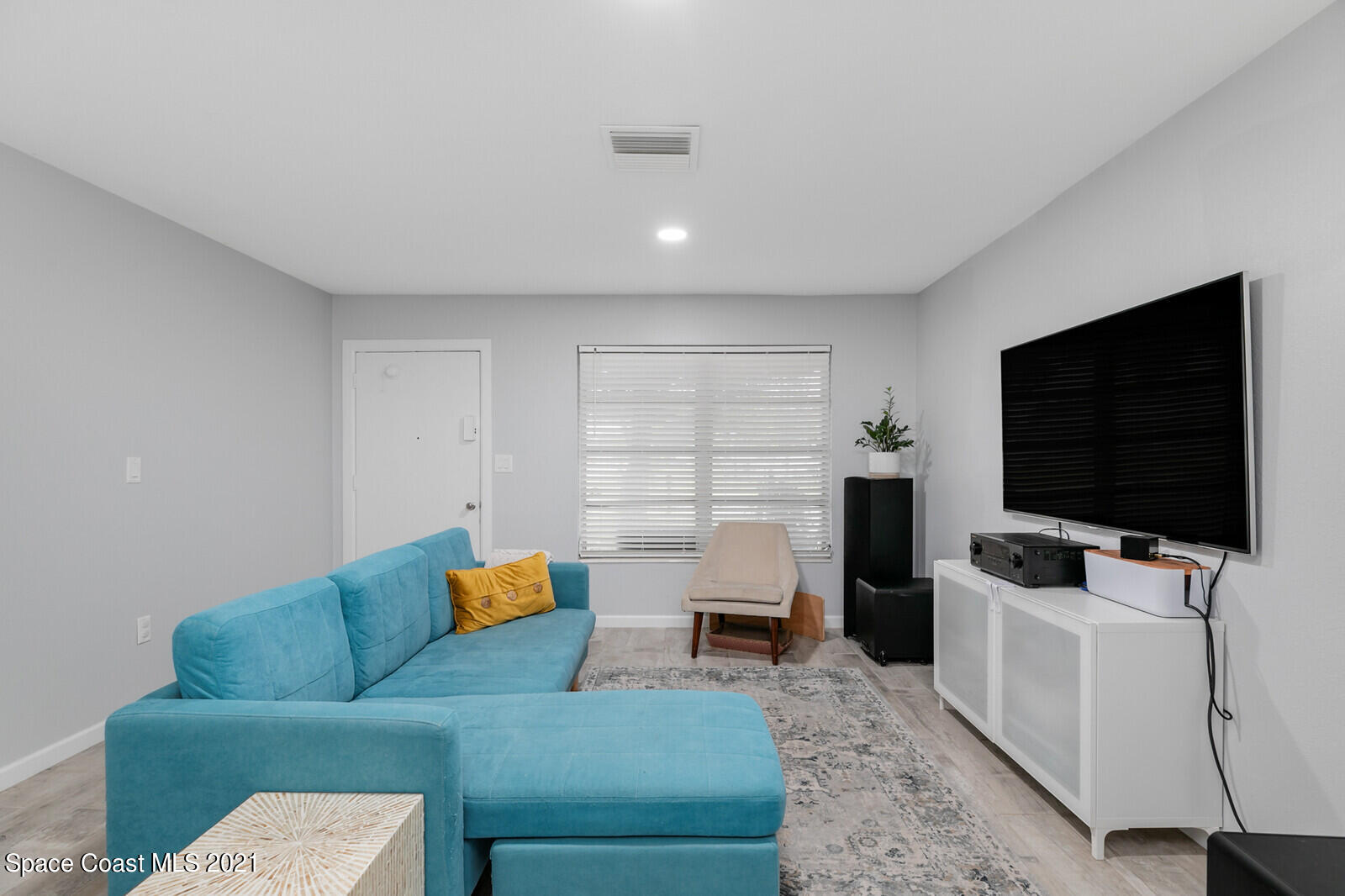 865 Osage Avenue Melbourne, FL 32935 - Photo 10 of 38 a living room with furniture and a flat screen tv