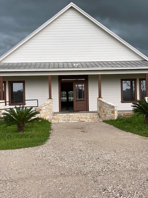 a front view of a house with a garden and plants