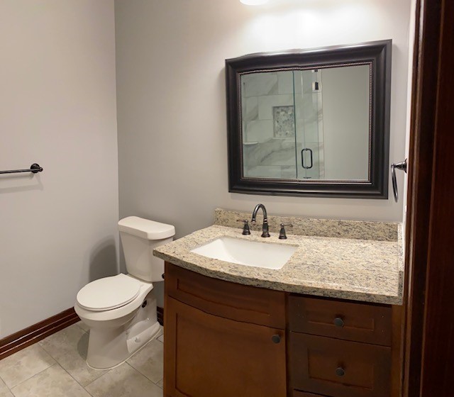 36100 Fm 1488 Hempstead, TX 77445 - Photo 4 of 10 a bathroom with a granite countertop toilet sink and mirror