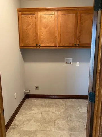 a view of room with wooden floor and cabinet
