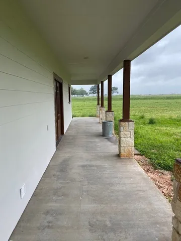 a view of a patio with a big yard