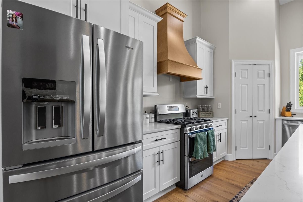 1489 Utley Road Camden, TN 38320 - Photo 13 of 60 a kitchen with stainless steel appliances and wooden cabinets
