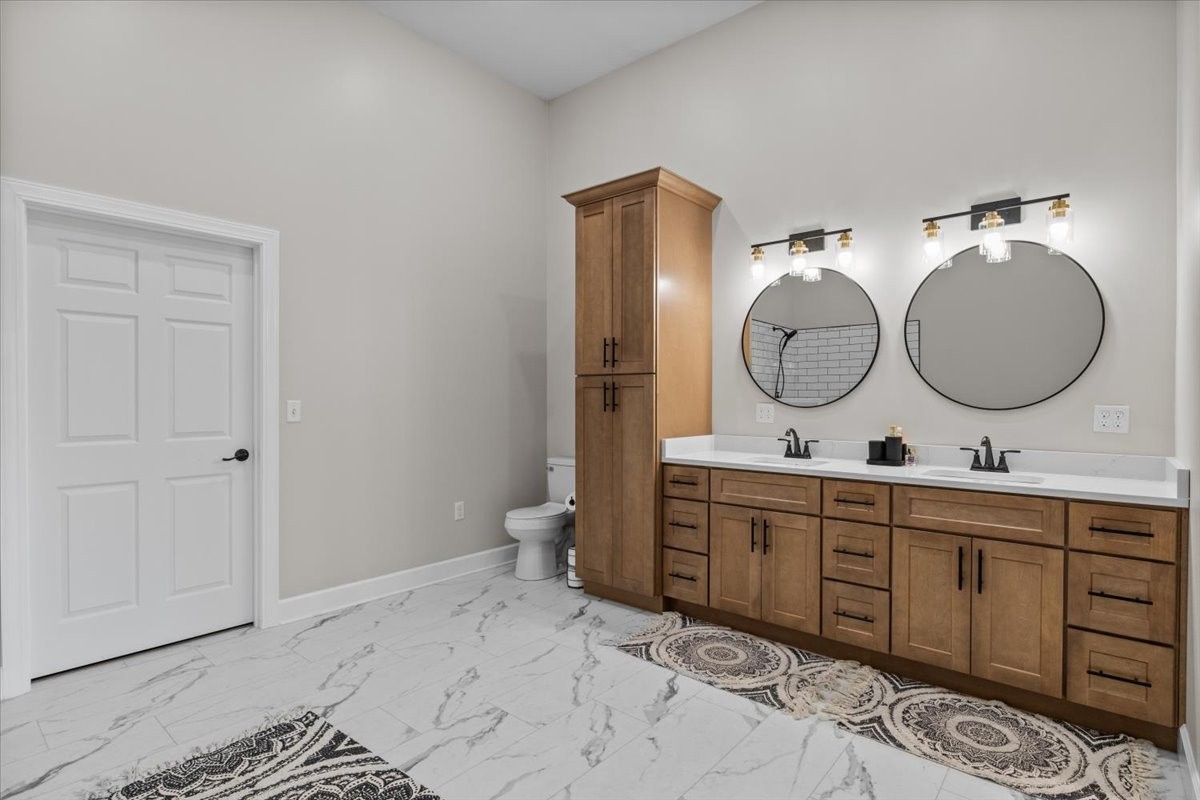 1489 Utley Road Camden, TN 38320 - Photo 19 of 60 a bathroom with a double vanity sink and a mirror
