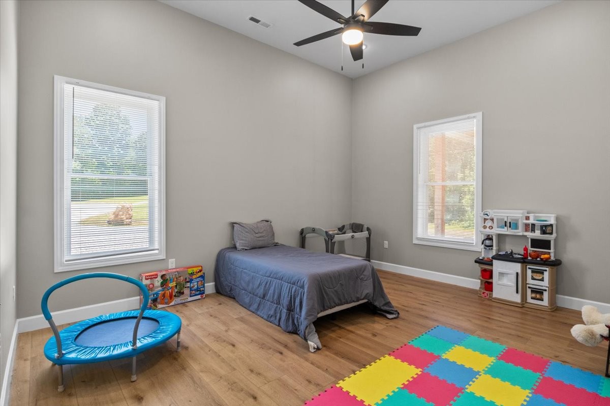 1489 Utley Road Camden, TN 38320 - Photo 30 of 60 a bedroom with a bed and a chandelier