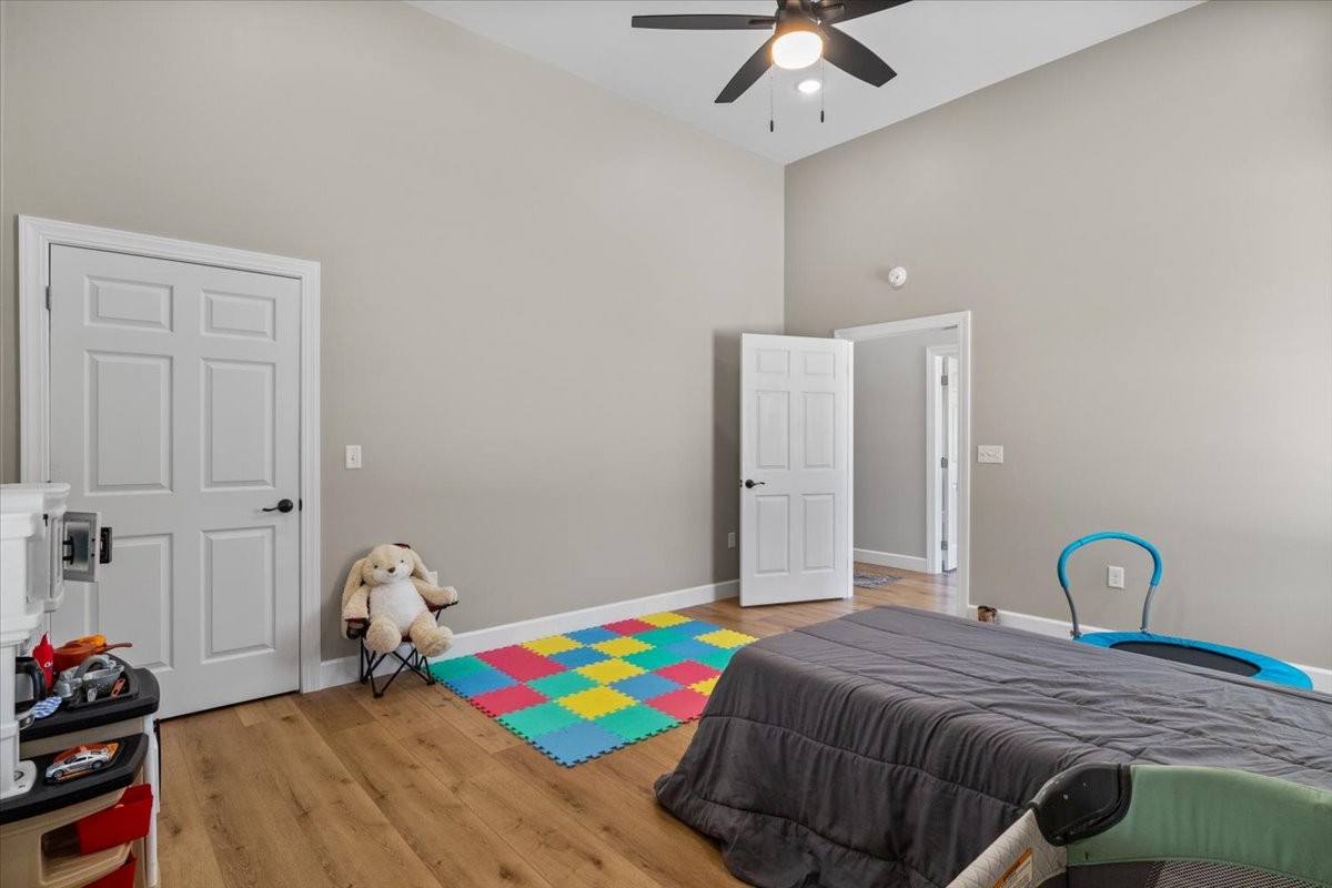 1489 Utley Road Camden, TN 38320 - Photo 31 of 60 a bedroom with a bed and a chandelier