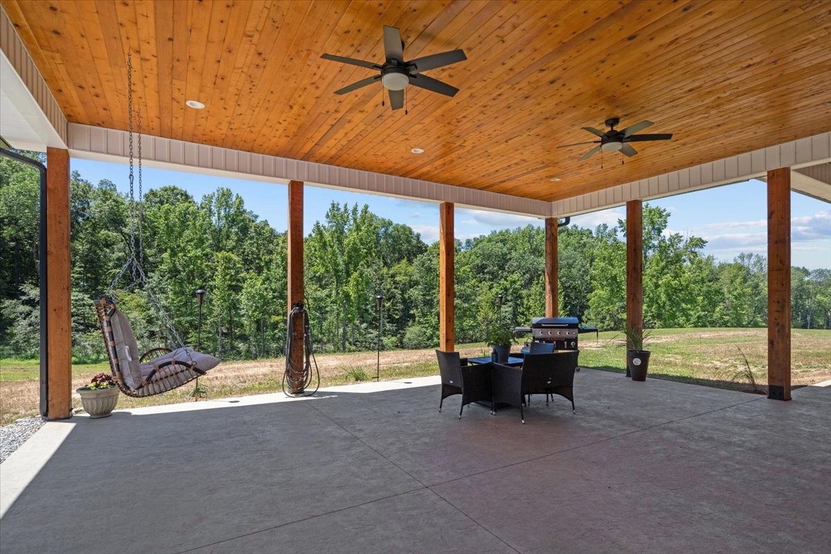 1489 Utley Road Camden, TN 38320 - Photo 35 of 60 a living room with hardwood floor and ceiling fan