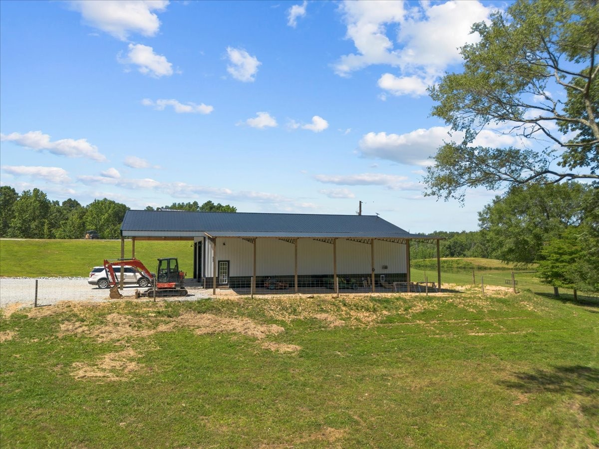 1489 Utley Road Camden, TN 38320 - Photo 46 of 60 a view of a lake with a house in the background