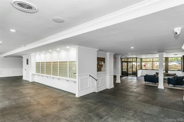 an empty room with windows and pillars in it