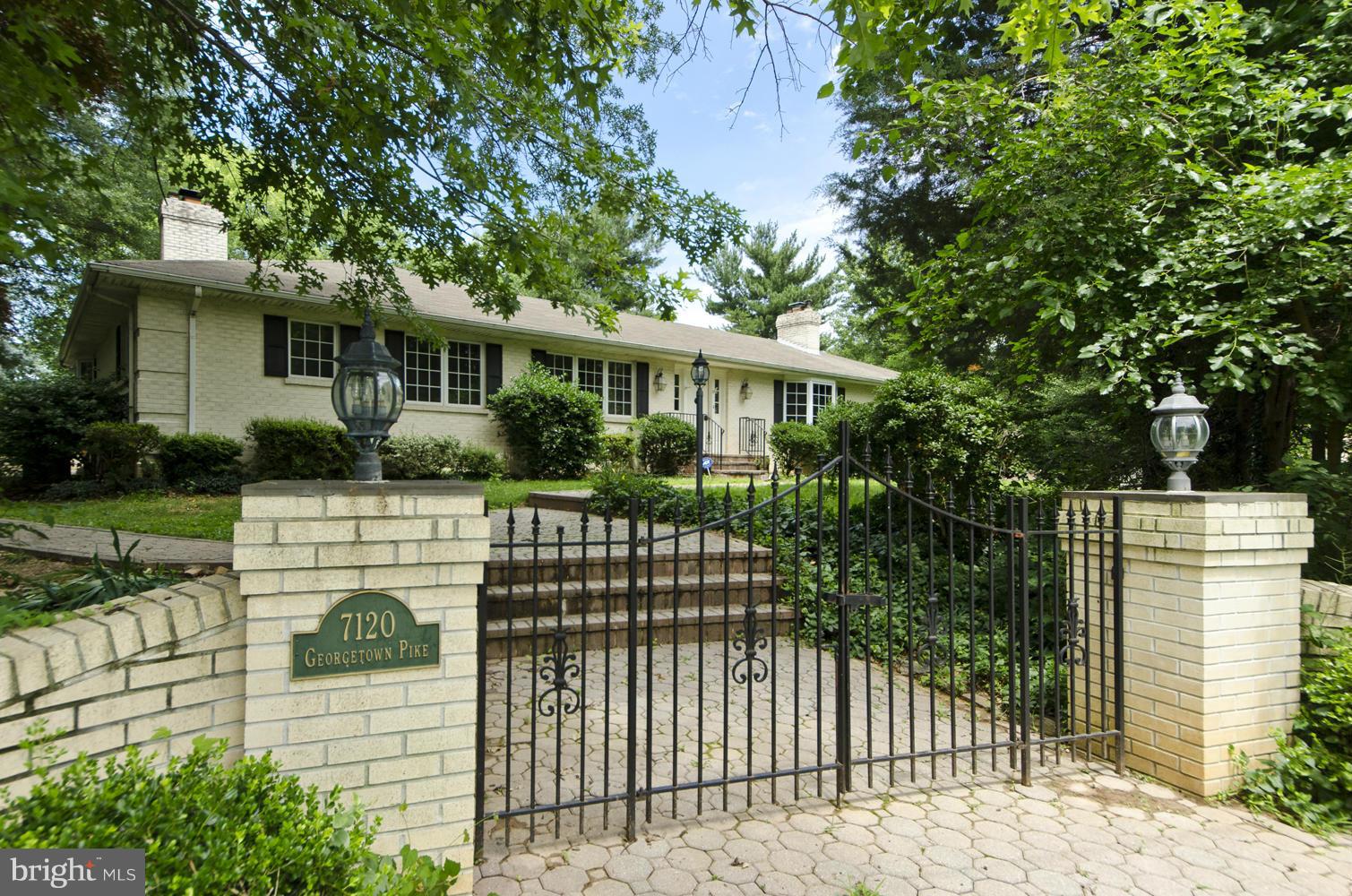 7120 Georgetown Pike McLean, VA 22101 - Photo 1 of 30 a front view of a house with a garden