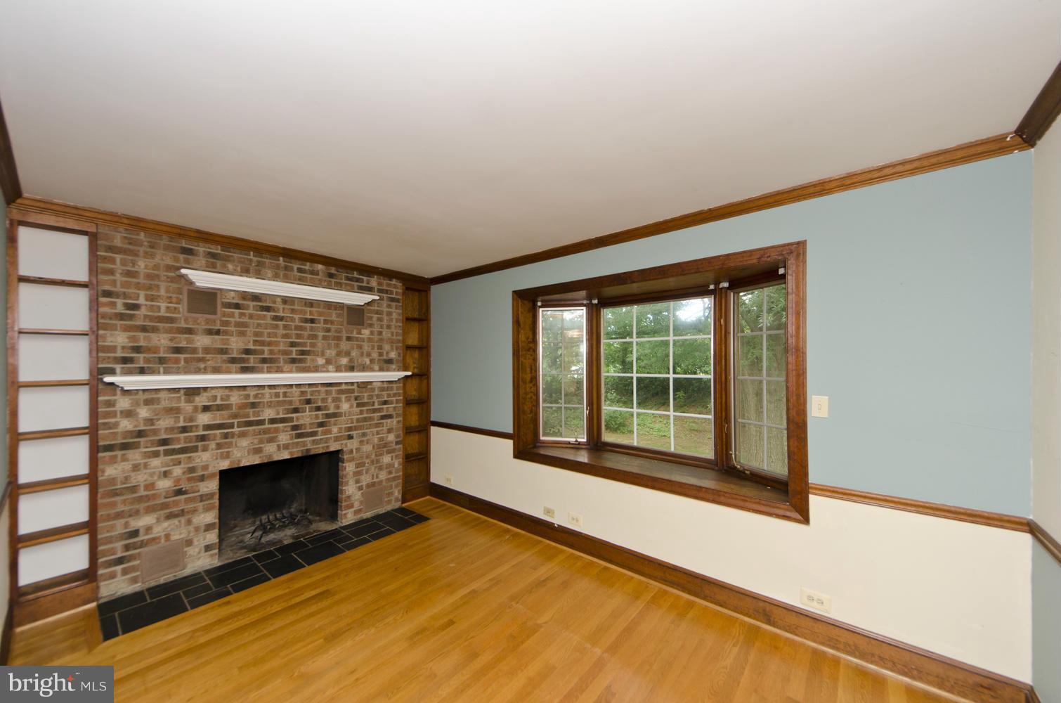 7120 Georgetown Pike McLean, VA 22101 - Photo 12 of 30 a living room with a fireplace and a floor to ceiling window