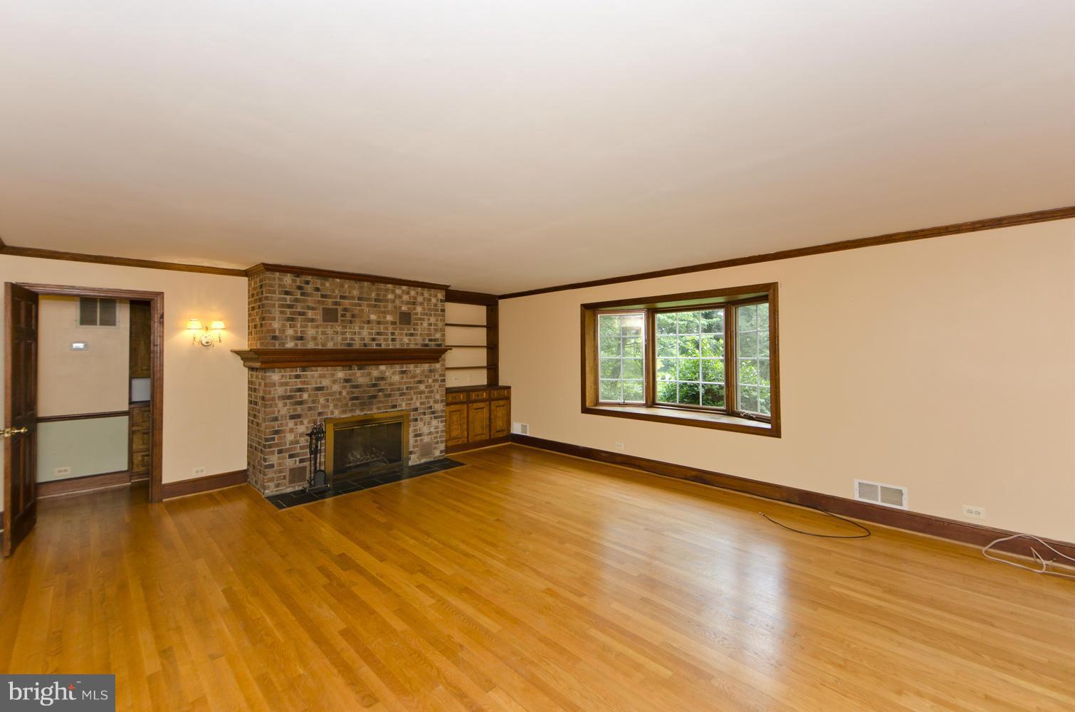 7120 Georgetown Pike McLean, VA 22101 - Photo 5 of 30 a view of an empty room with a window and wooden floor