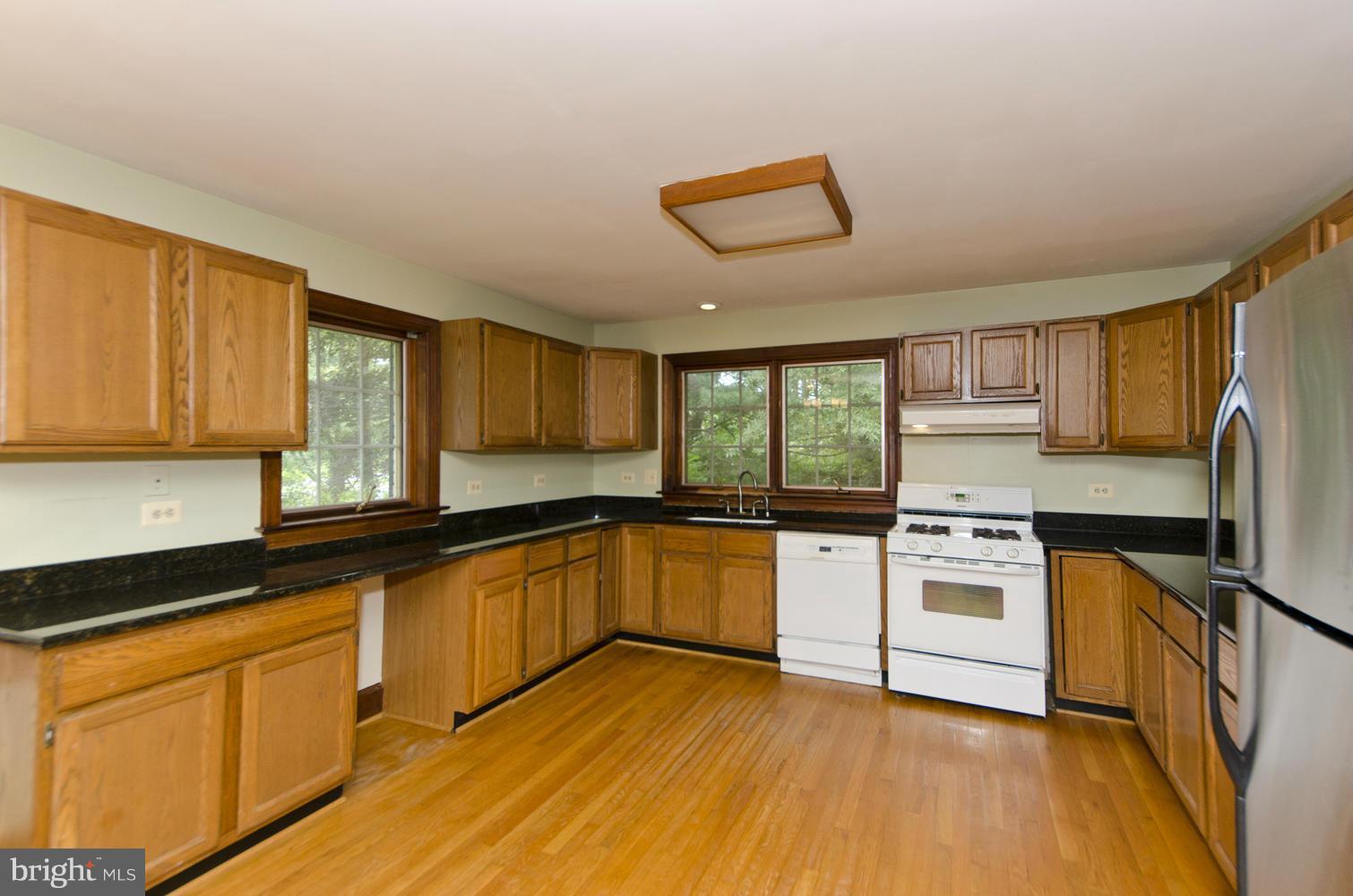 7120 Georgetown Pike McLean, VA 22101 - Photo 10 of 30 a kitchen with granite countertop white cabinets and white appliances