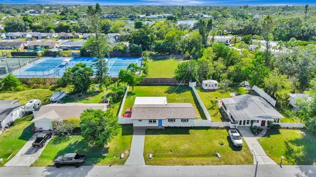 an aerial view of a house with a swimming pool yard and outdoor seating