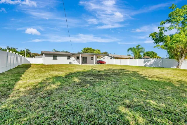 a view of a swimming pool with an outdoor seating and a yard