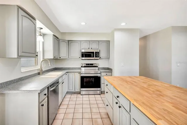 a kitchen with a sink stove and microwave