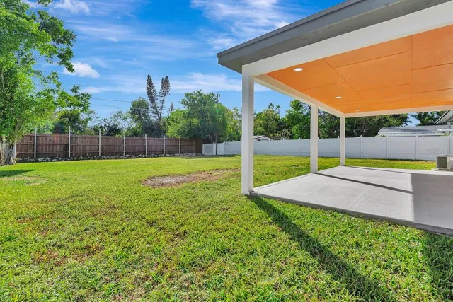 a view of a backyard with swimming pool
