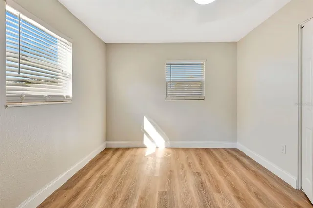 wooden floor in an empty room with a window