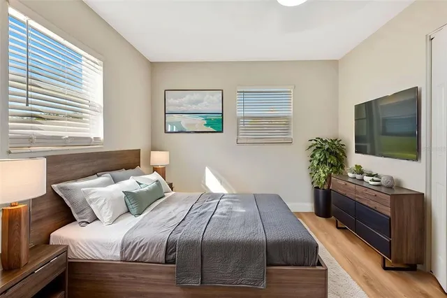 a bedroom with a bed and a flat screen tv