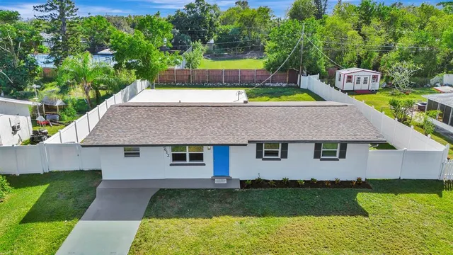 a aerial view of a house with a yard