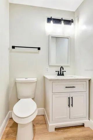 a bathroom with a toilet sink and vanity