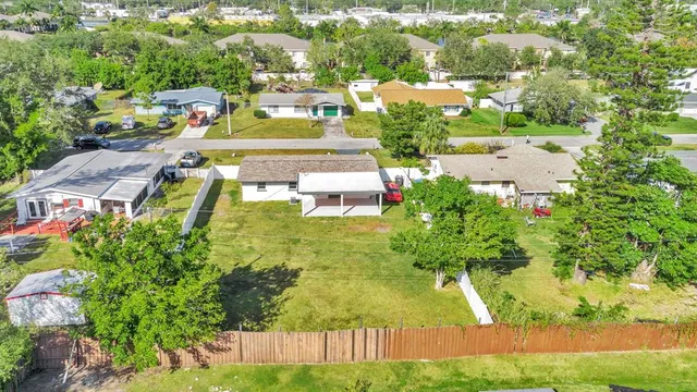 an aerial view of residential houses with yard