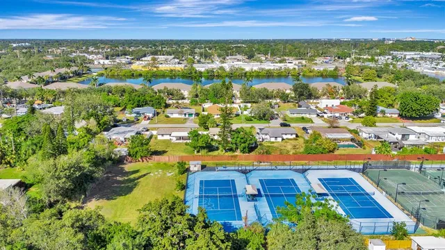 an aerial view of residential houses with outdoor space and swimming pool