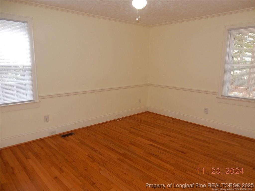 708 Rush Road Fayetteville, NC 28305 - Photo 12 of 17 an empty room with wooden floor and windows