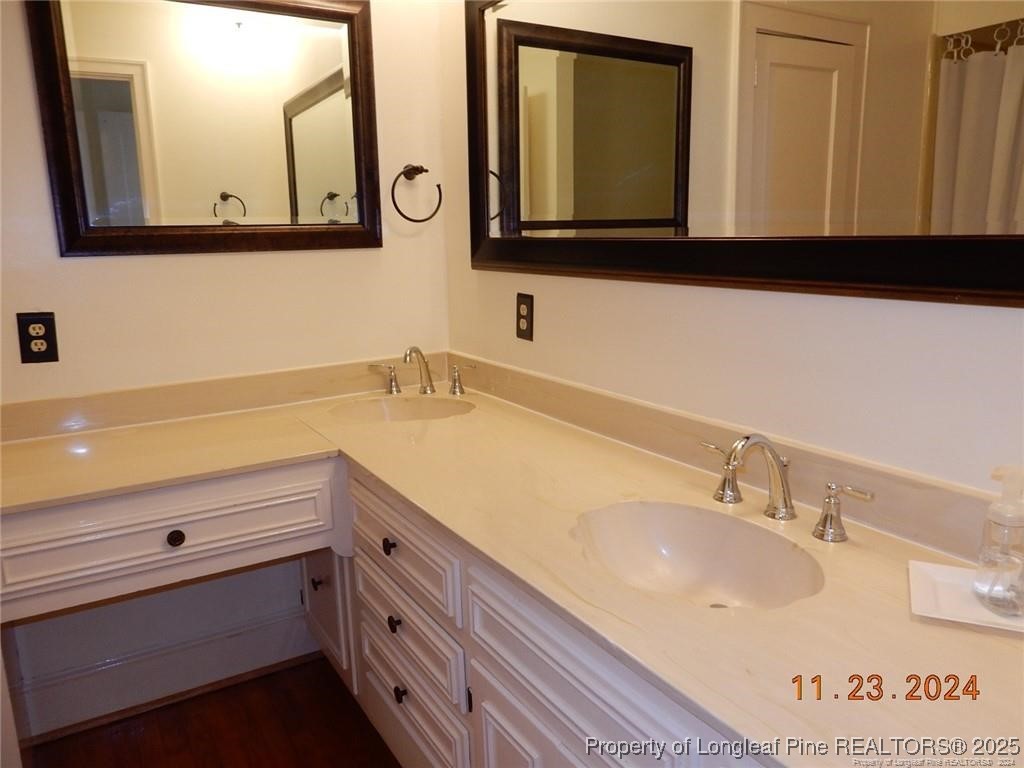 708 Rush Road Fayetteville, NC 28305 - Photo 14 of 17 a bathroom with a sink mirror and vanity