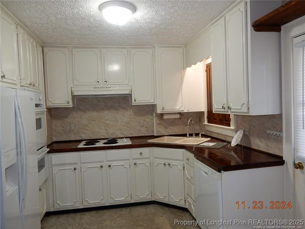 708 Rush Road Fayetteville, NC 28305 - Photo 9 of 17 a kitchen with a sink and cabinets