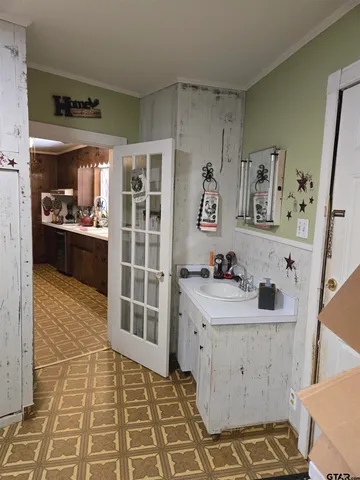 a room with a baby crib and a dresser