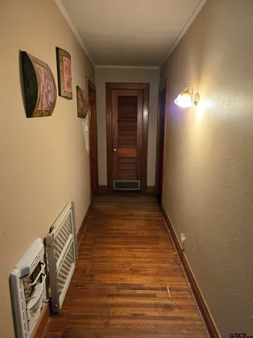 a view of a hallway with wooden floor