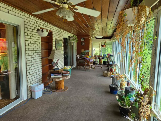a view of a patio with table and chairs potted plants with wooden floor