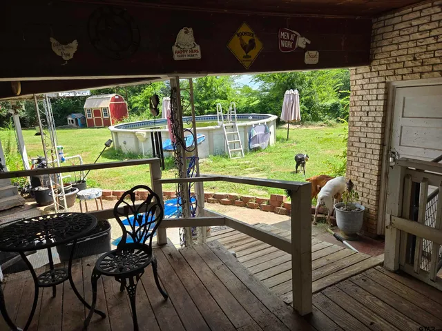 a view of a chairs and a table in the patio
