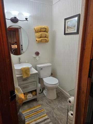 a bathroom with a toilet a sink and a mirror